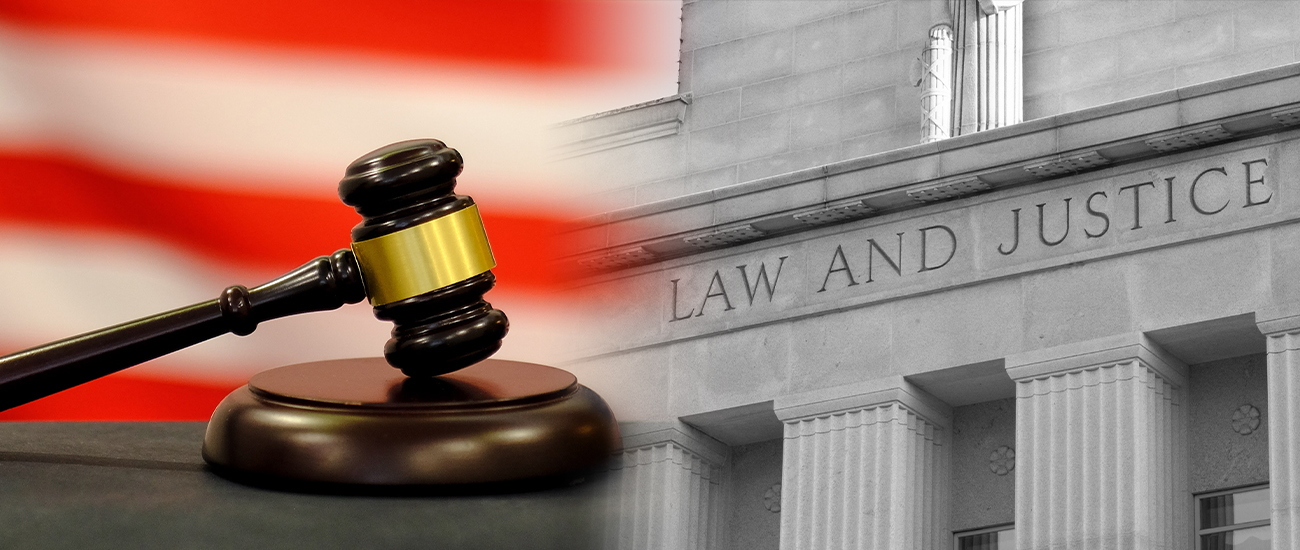  image displays a close-up of a wooden gavel set against a background with the American flag, alongside the engraved words 